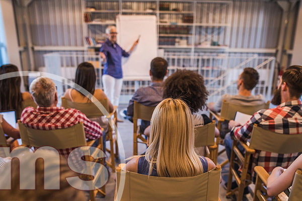 homeowner giving a presentation in a board room | plan hoa meeting