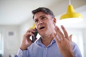 Frustrated Mature Man Talking On Phone | dealing with difficult homeowners