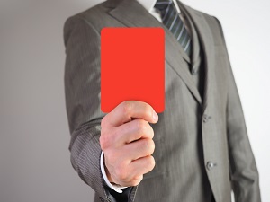 man in suit holding a red card | dealing with hoa violations