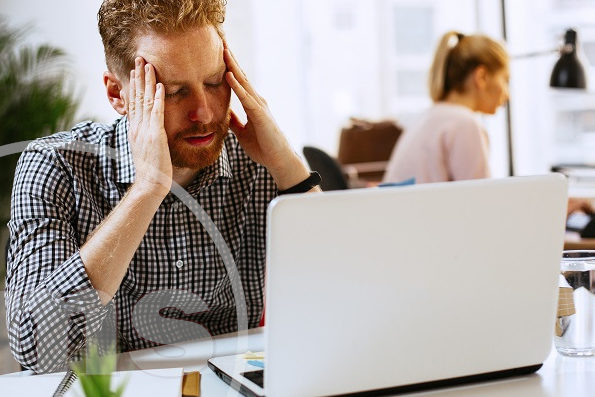 problematic man in front of laptop putting hands on head | issues at your hoa