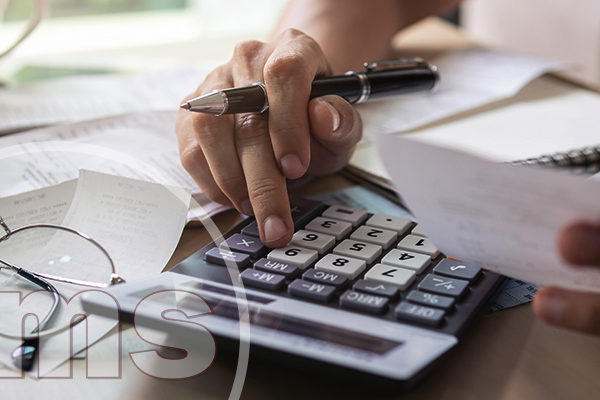 Stressed young woman checking bill | assessments during coronavirus