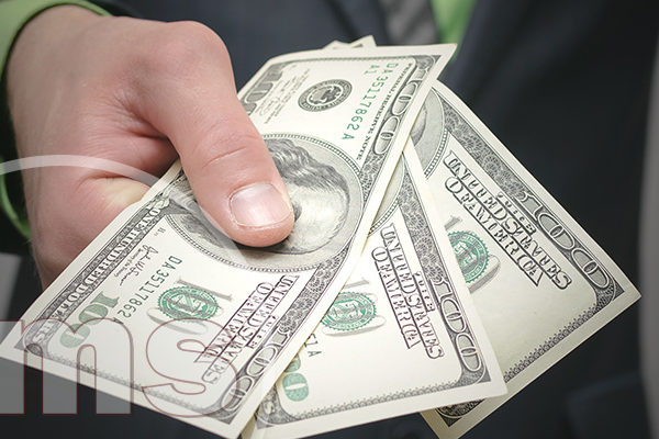 Is Asking For HOA Special Assessments Allowed homeowner holding dollar bills | hoa special assessments