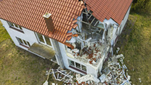 damaged red single house roof after a tornado | emergency preparedness planning