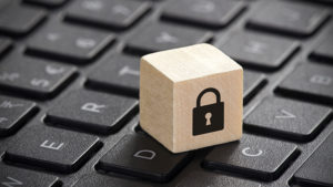 Wooden block with lock graphic on laptop keyboard | hoa records maintenance